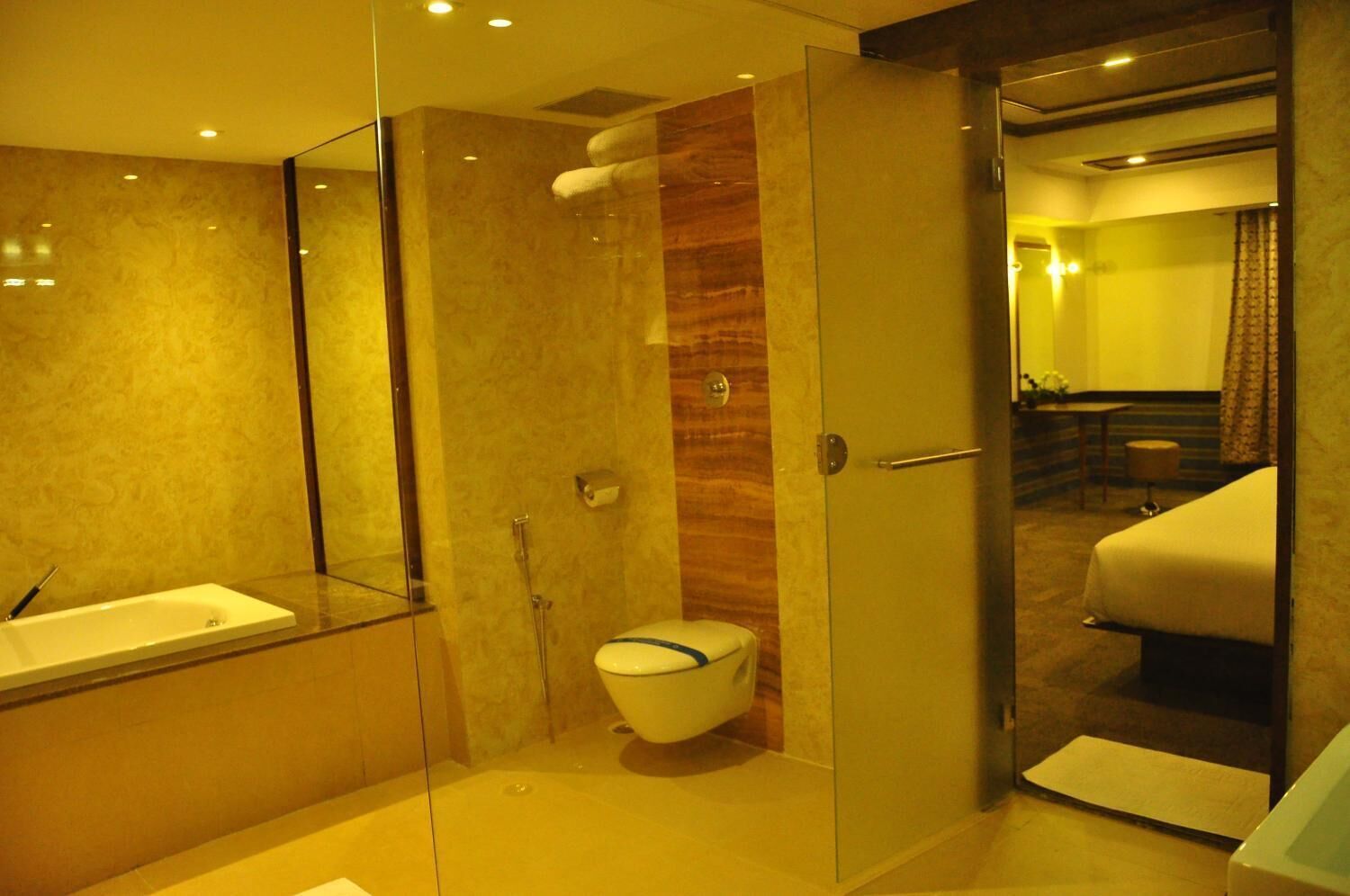 A modern bathroom with a glass-enclosed shower, a white toilet, and a separate sink.