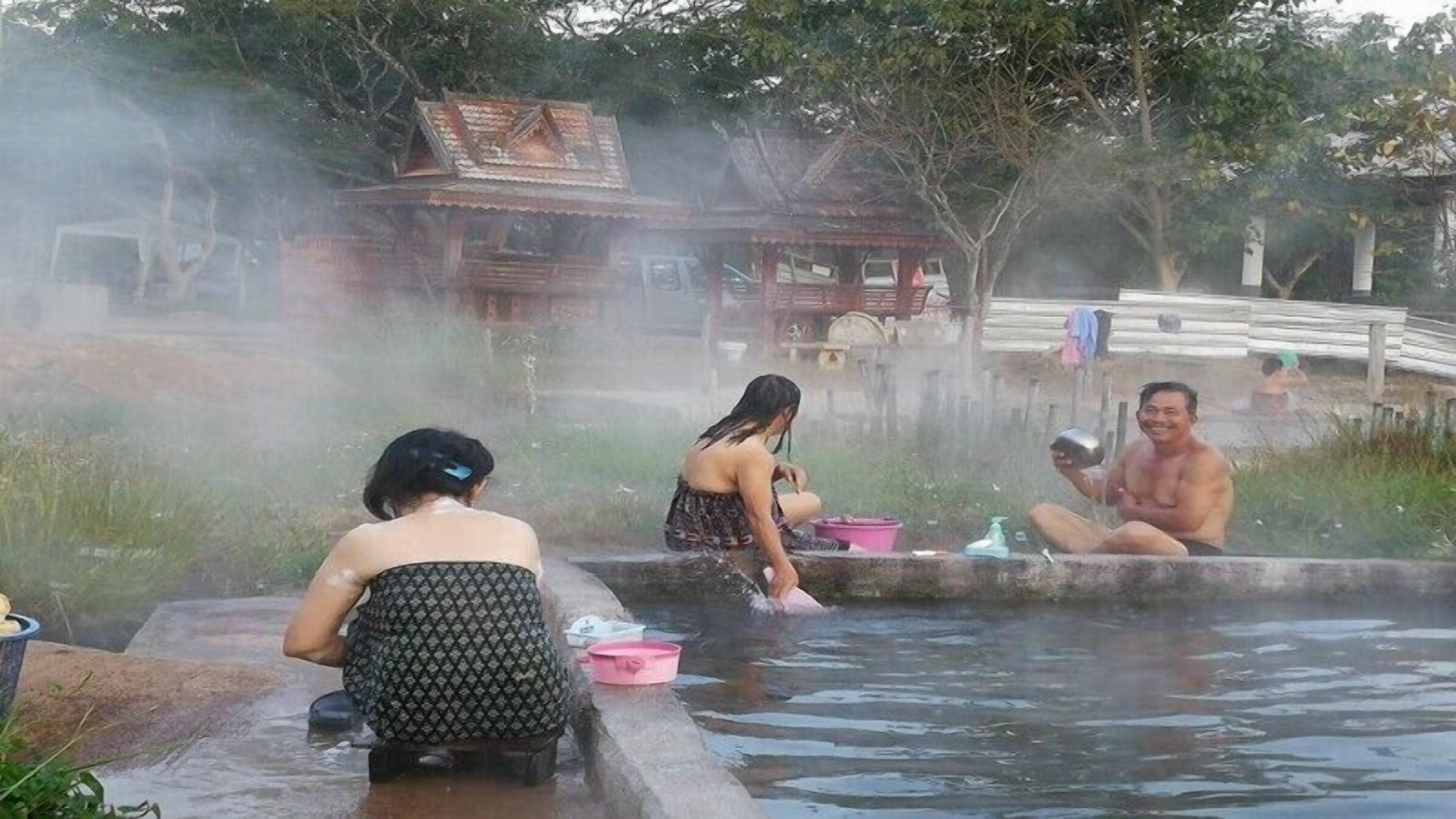 A hot spring area with people relaxing in the water.