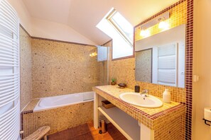 Bathtub, eco-friendly toiletries, hair dryer, towels
