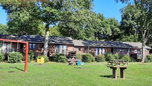 A row of log cabins with a playground and picnic tables in a grassy area. - Cozy chalet in a quiet, green area (Rendeux)