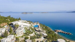 A coastal hotel with a pool, multiple buildings, and a marina. - Duja Bodrum - All Inclusive (Bodrum)