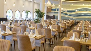 A spacious dining area with multiple tables and chairs, large windows, and modern lighting fixtures. - Duja Bodrum (Bodrum)
