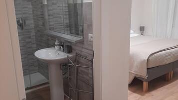Een douche, een haardroger, een bidet, handdoeken