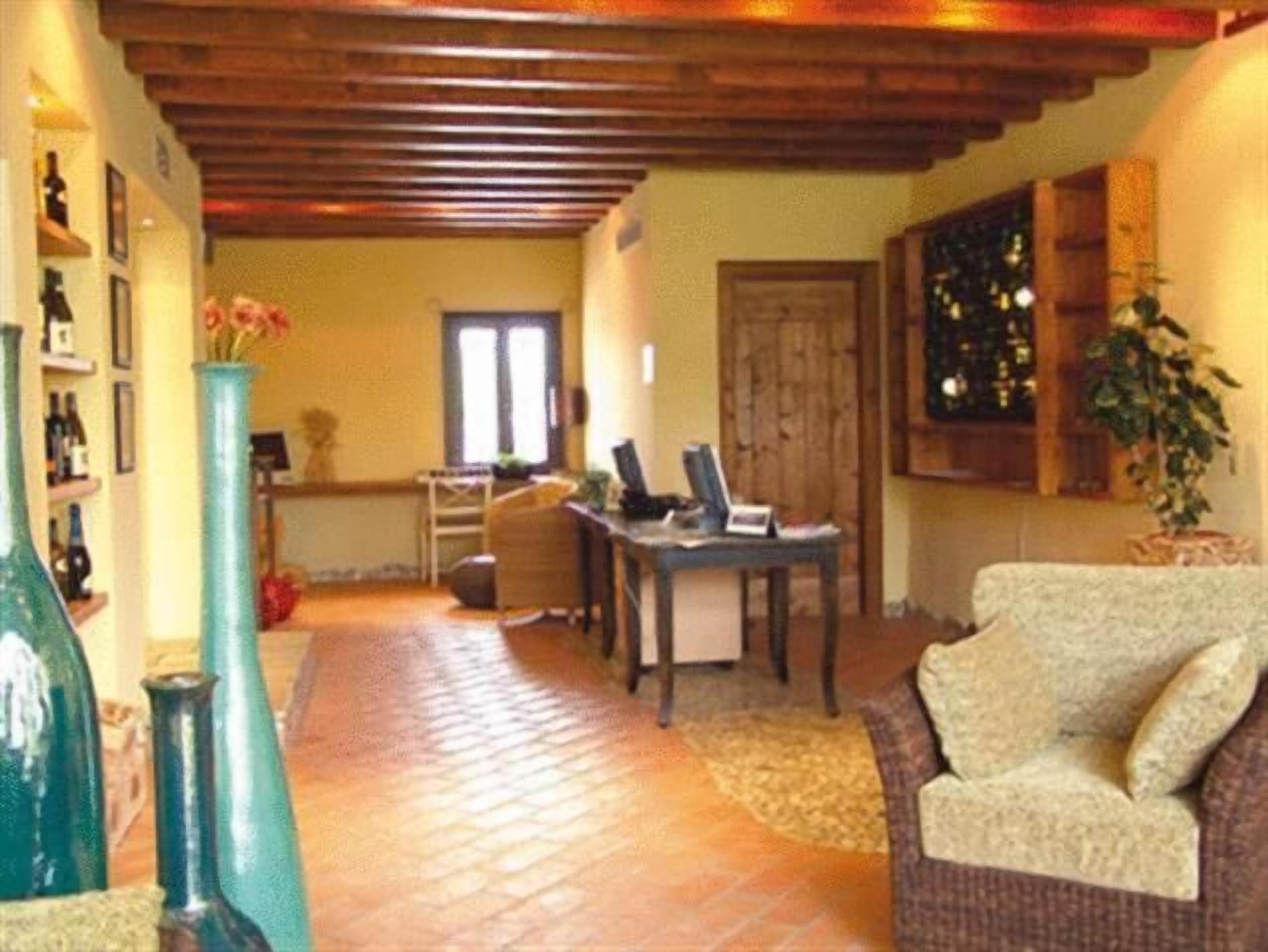 A cozy living area with a tiled floor, a sofa, a coffee table, and a bookshelf.