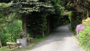 A paved pathway in a park with benches and trees. - Comfortable house in Bohemian Paradise with swimming pool, internet (Turnov)