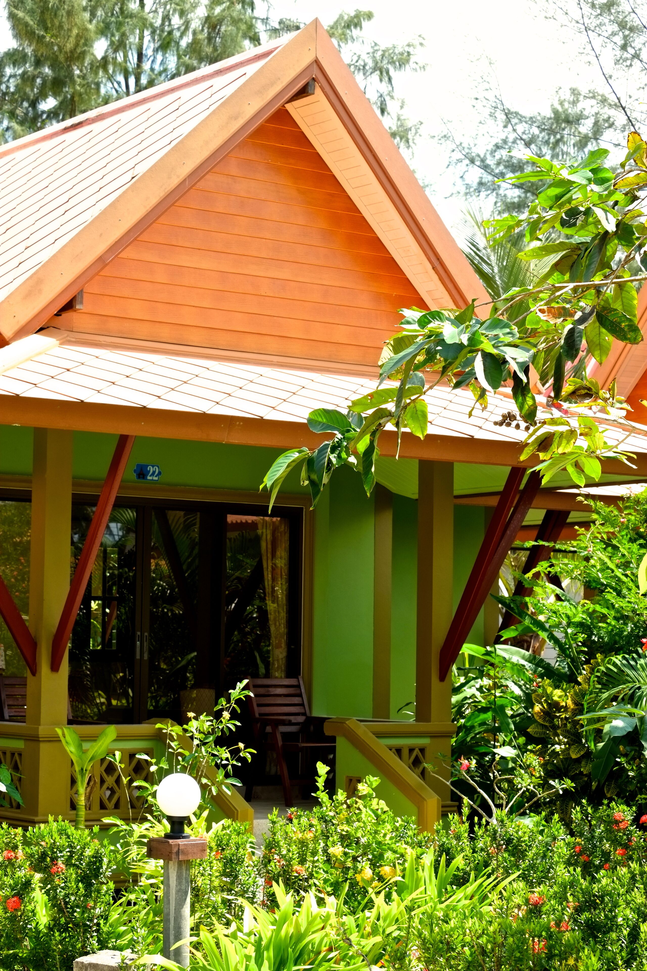 A building with a sloped roof and a porch.