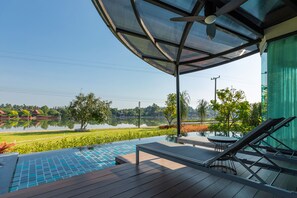 A rooftop pool area with a view of a lake and greenery. - Na Tree Tara Riverside Resort Amphawa Damnoensaduak (Bang Khonthi)