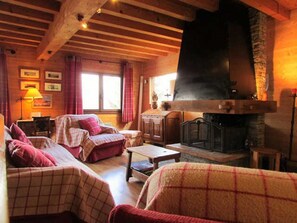 Cozy living room with a fireplace, two sofas, and a traditional homey feel.