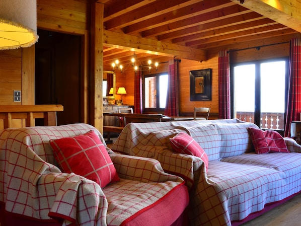 Relax in this inviting room with a comfortable sofa, dining table, and bench.