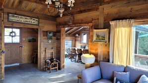 A wooden cabin interior with a dining area, a sofa, and a fireplace. - Les Eterlous - Very beautiful Chalet 200m from the slopes of La Plagne - 12-15 pers. (Aime-La-Plagne)