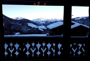 Enjoy breathtaking views of snow-covered mountains from this balcony.