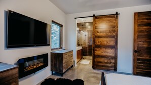 A modern bathroom with a large mirror, wooden sliding doors, and a built-in sink. - Gate Access To 1.5 million Acre Carson National Forest! (Angel Fire)