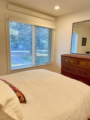 A bedroom with a large bed, a dresser, and a window with blinds. - SV121 - Walk to Lifts & Town - Hot Tub & Pool (Ketchum)