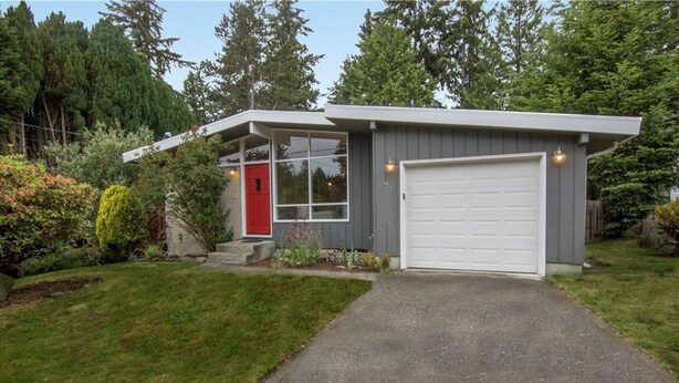 A modern single-story house with a garage, a red door, and a well-maintained garden. - Beautiful Home with Traditional & Modern Ambience (Edmonds)