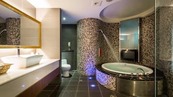 Een aparte badkuip en douche, een bubbelbad, een regendouche