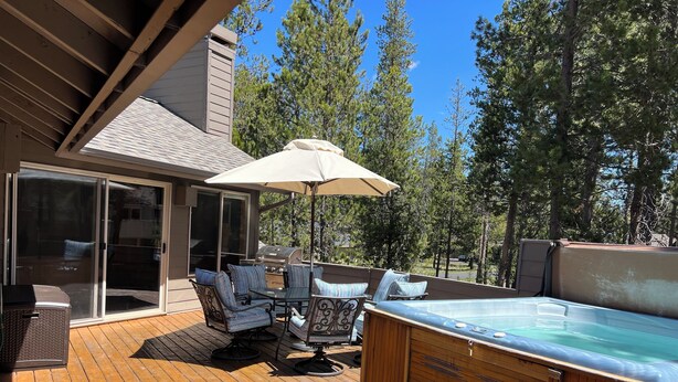 An outdoor deck with a hot tub, patio furniture, and a grill. - NEW Mountain Home at the Deschutes River,Bikes,Game Room,Hot Tub,AC,SHARC Passes (Bend)