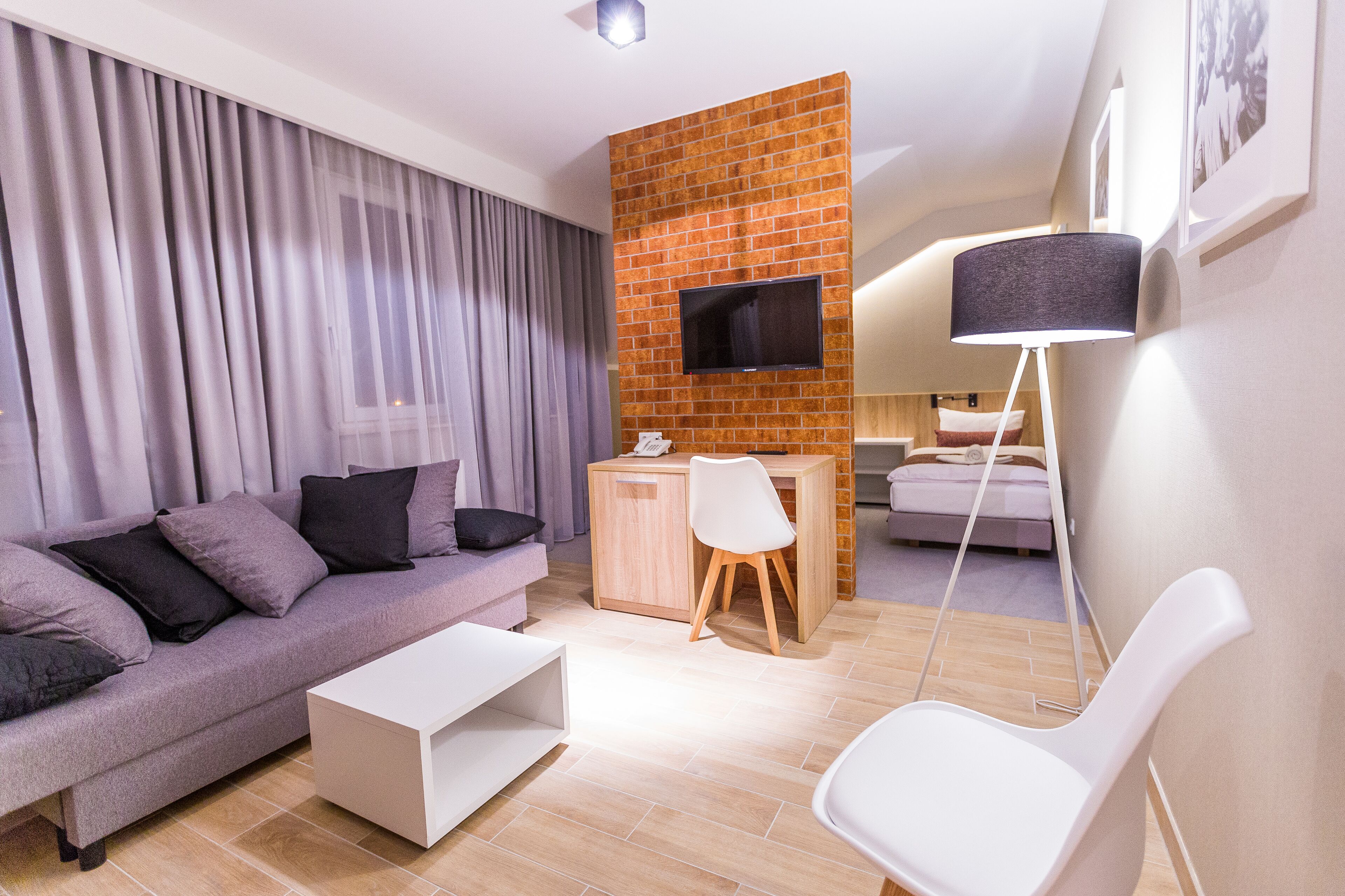 deluxe double room | living area | flat-screen tv