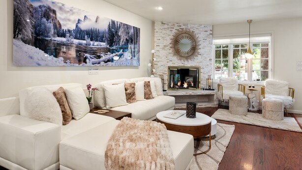 A modern living room with a fireplace, white sofas, and a large winter landscape painting. -  Aspen Core Designer 4 Bdrm, Walk to Everything , A/C, Parking (Aspen)