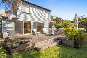 A house with a deck, outdoor furniture, and a statue. - CAPTIVATING CENTENARY BEACH HOUSE IN BLAIRGOWRIE (Blairgowrie)