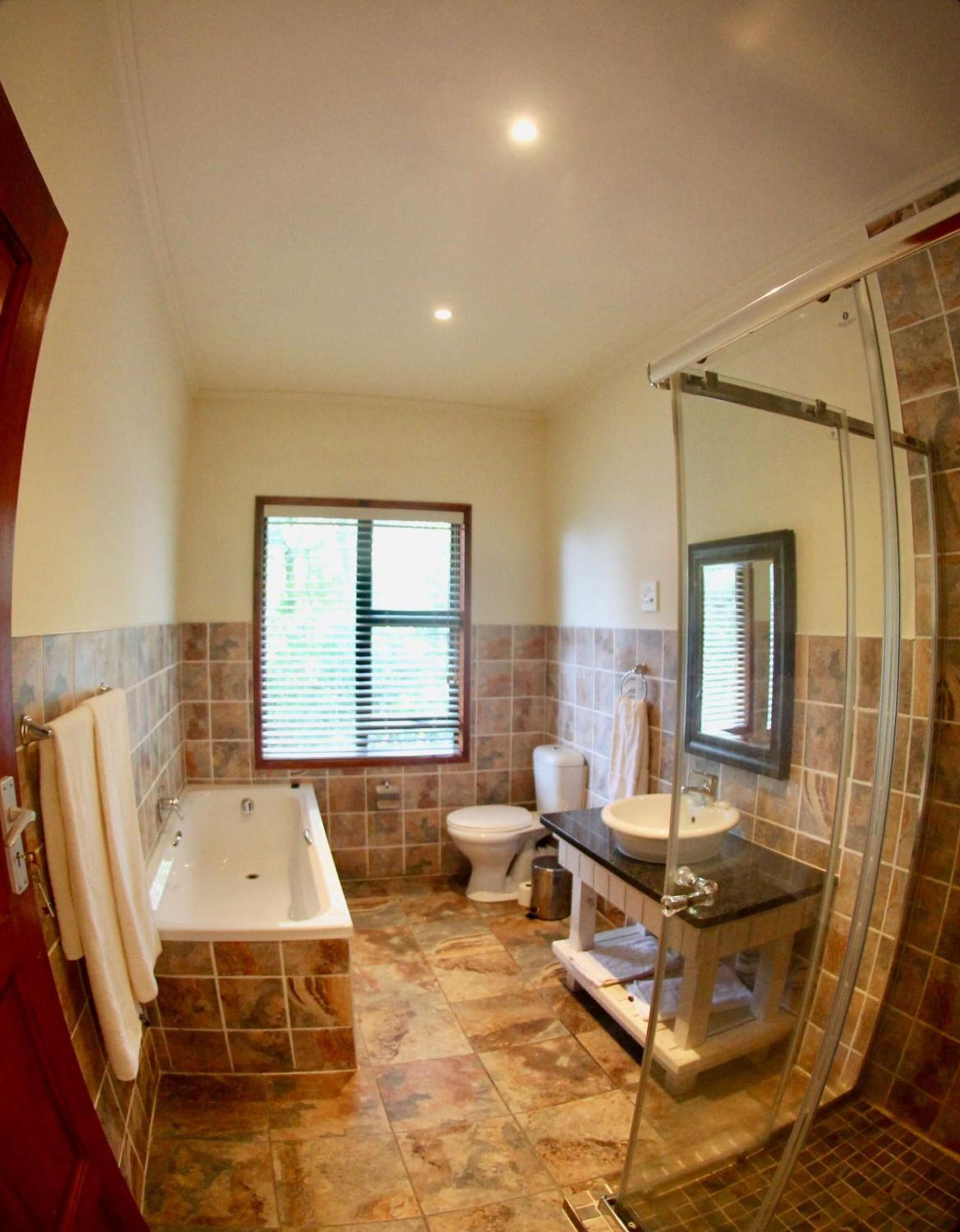 A bathroom with a bathtub, toilet, and sink.
