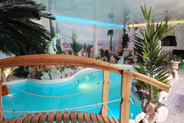 Indoor pool, open 9:00 AM to 9:00 PM, pool loungers