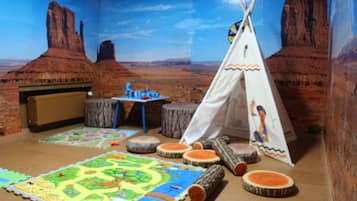 Explore a desert-themed play area with a colorful play mat, play table, and teepee.