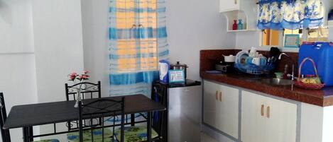 Full-size fridge, stovetop, electric kettle, rice cooker