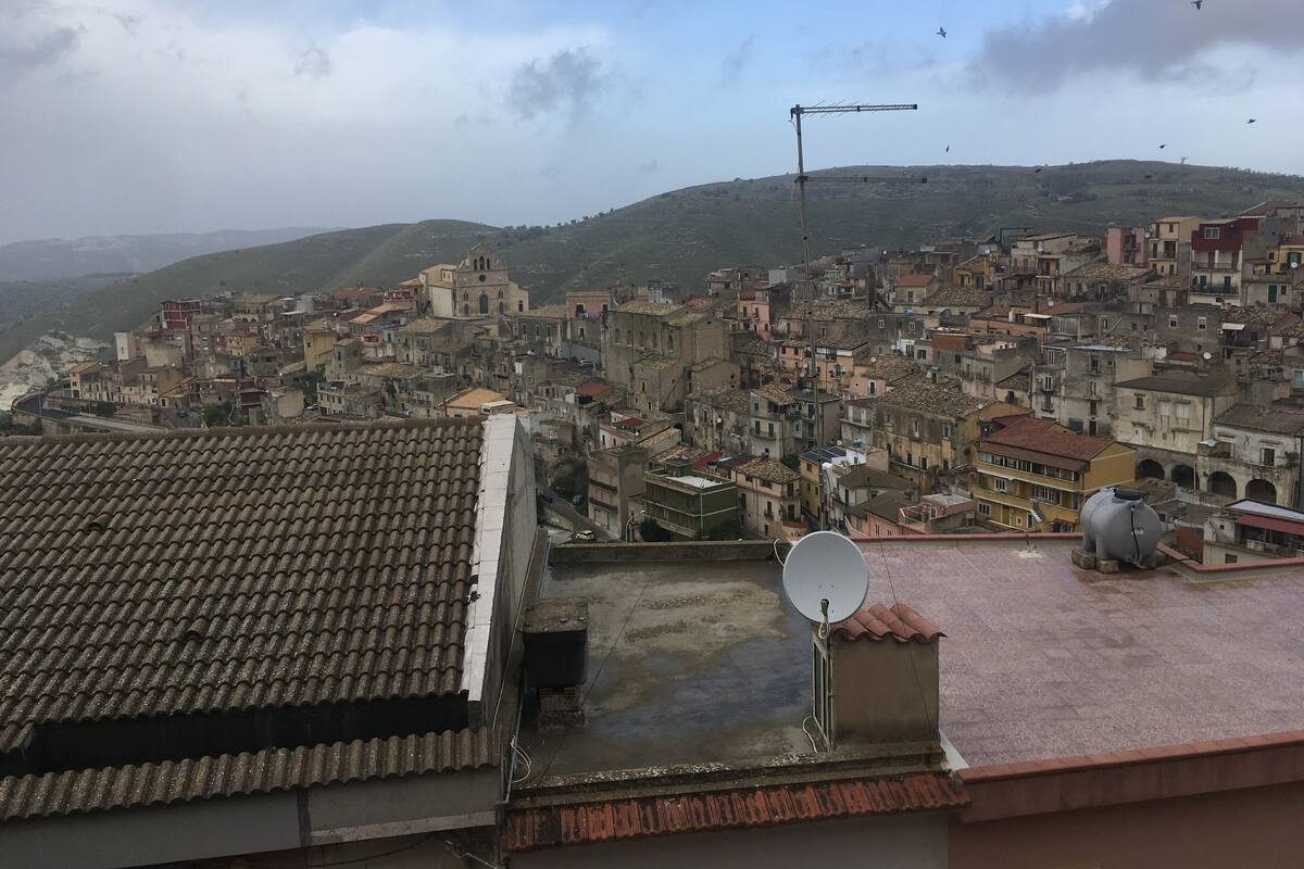 A densely packed urban area with historical buildings, a prominent church, and a satellite dish on a rooftop.