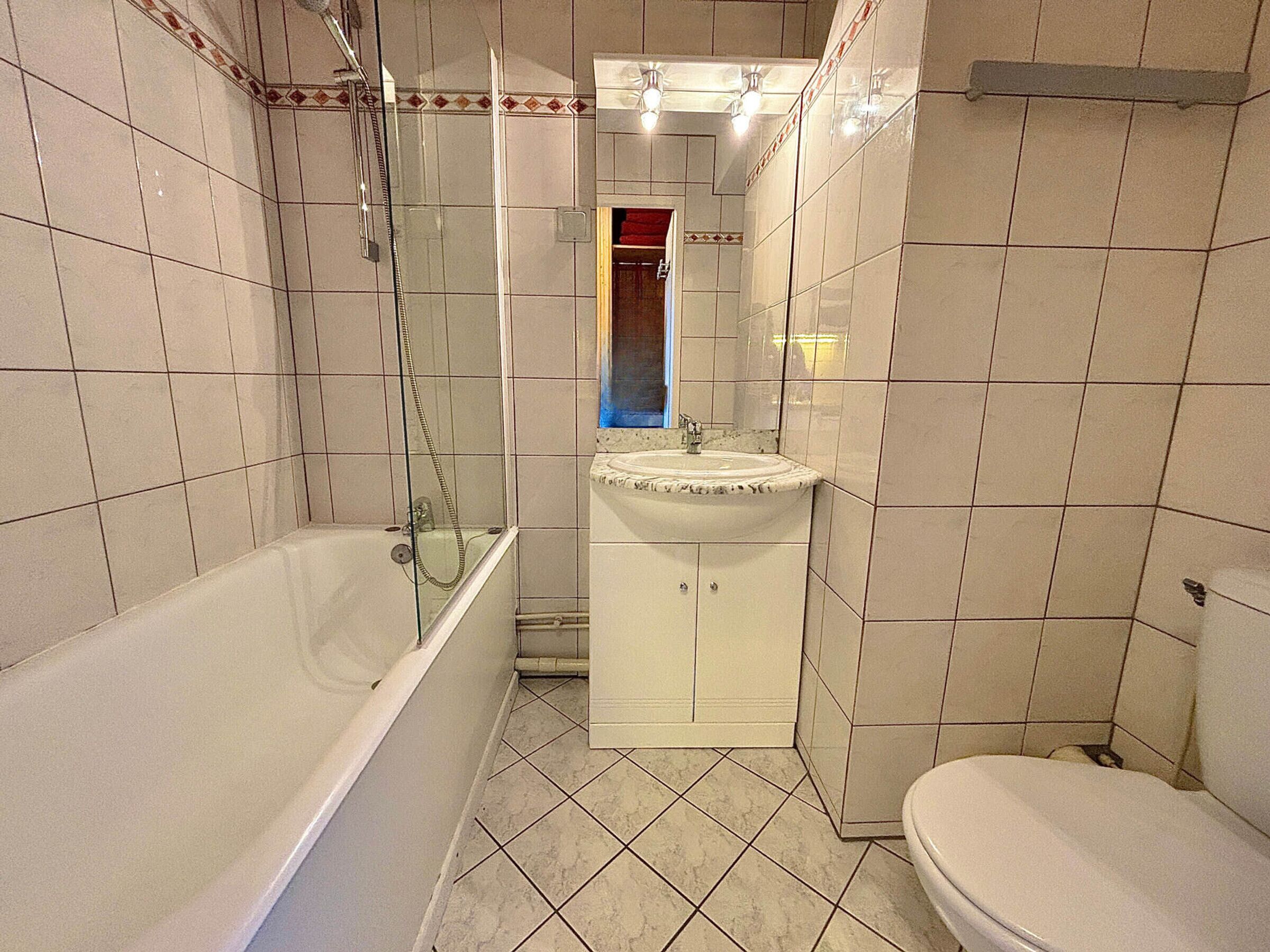 A bathroom with a bathtub, a sink, and a toilet.
