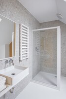 Shower, rainfall showerhead, hair dryer, towels