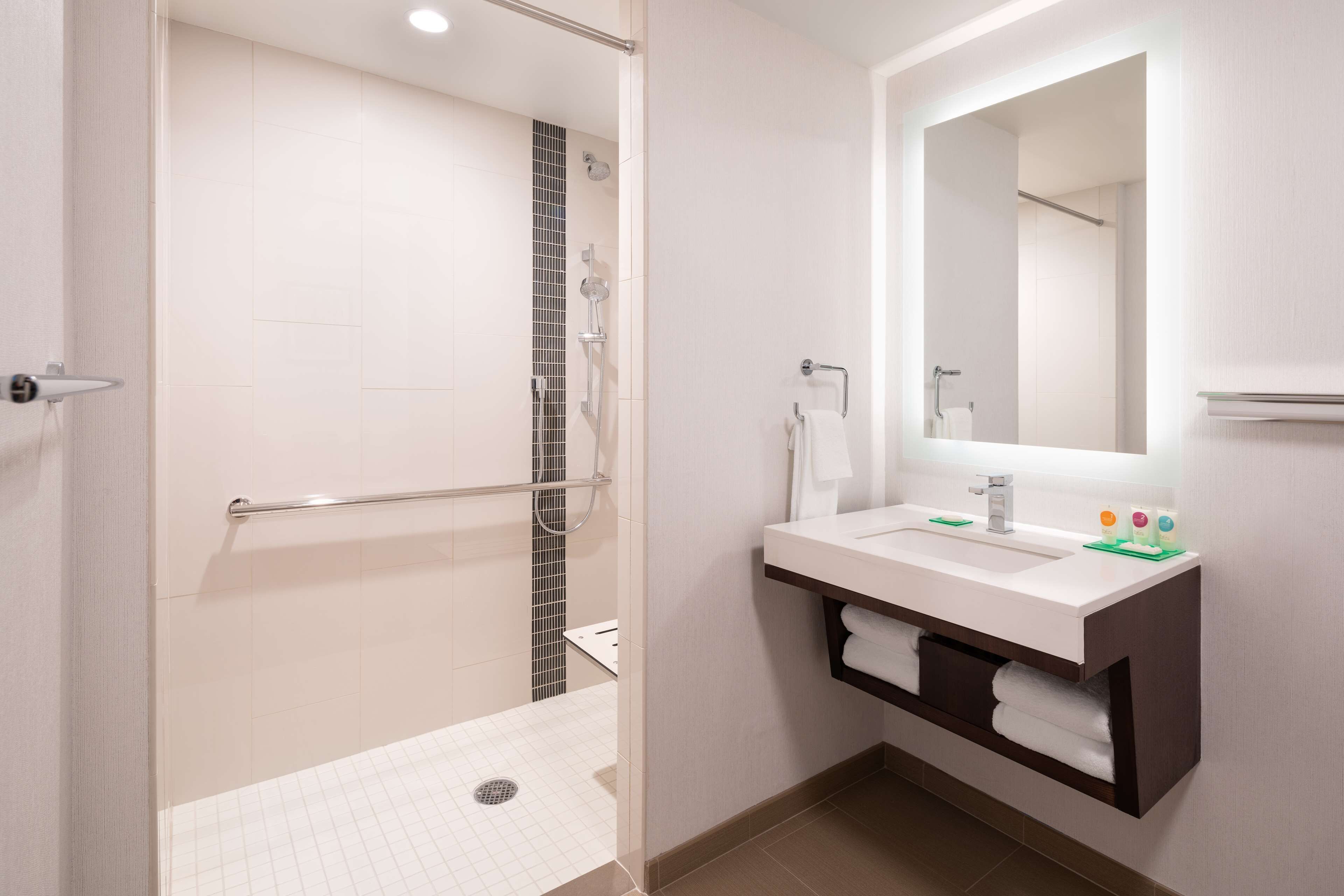 designer toiletries, hair dryer, towels, soap