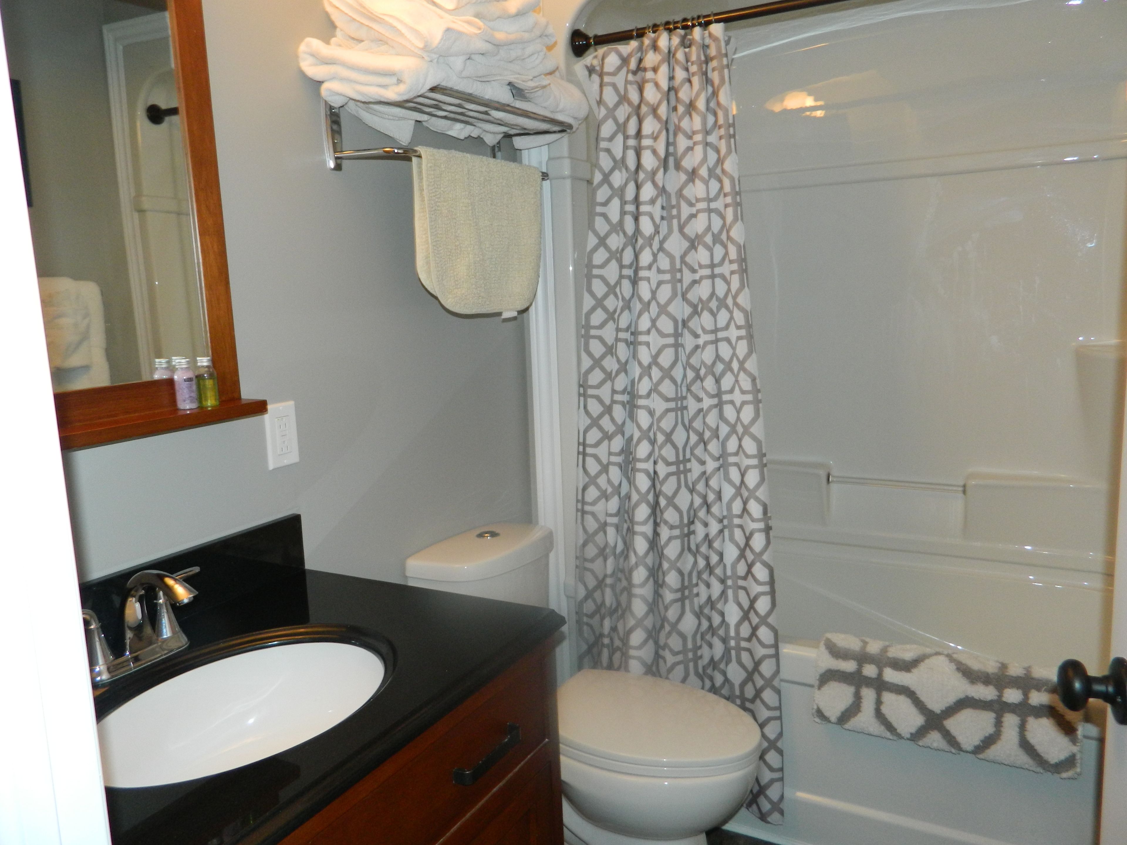 A bathroom with a sink, toilet, and shower curtain.