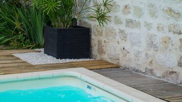 Seasonal outdoor pool, open 2:00 PM to 7:00 PM, pool umbrellas