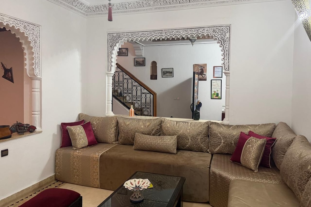A living room with a sofa, coffee table, and decorative pillows.