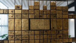 A wall with a grid of wooden panels in a modern interior space. - MyPlace Zócalo (Mexico City)