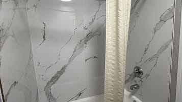 Bathtub, free toiletries, towels, soap