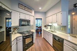 Enjoy cooking in this well-lit kitchen with an oven, dishwasher, and stainless steel appliances.