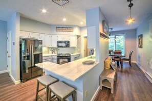 Enjoy cooking in this well-equipped kitchen with a central island, gas stove, and refrigerator.