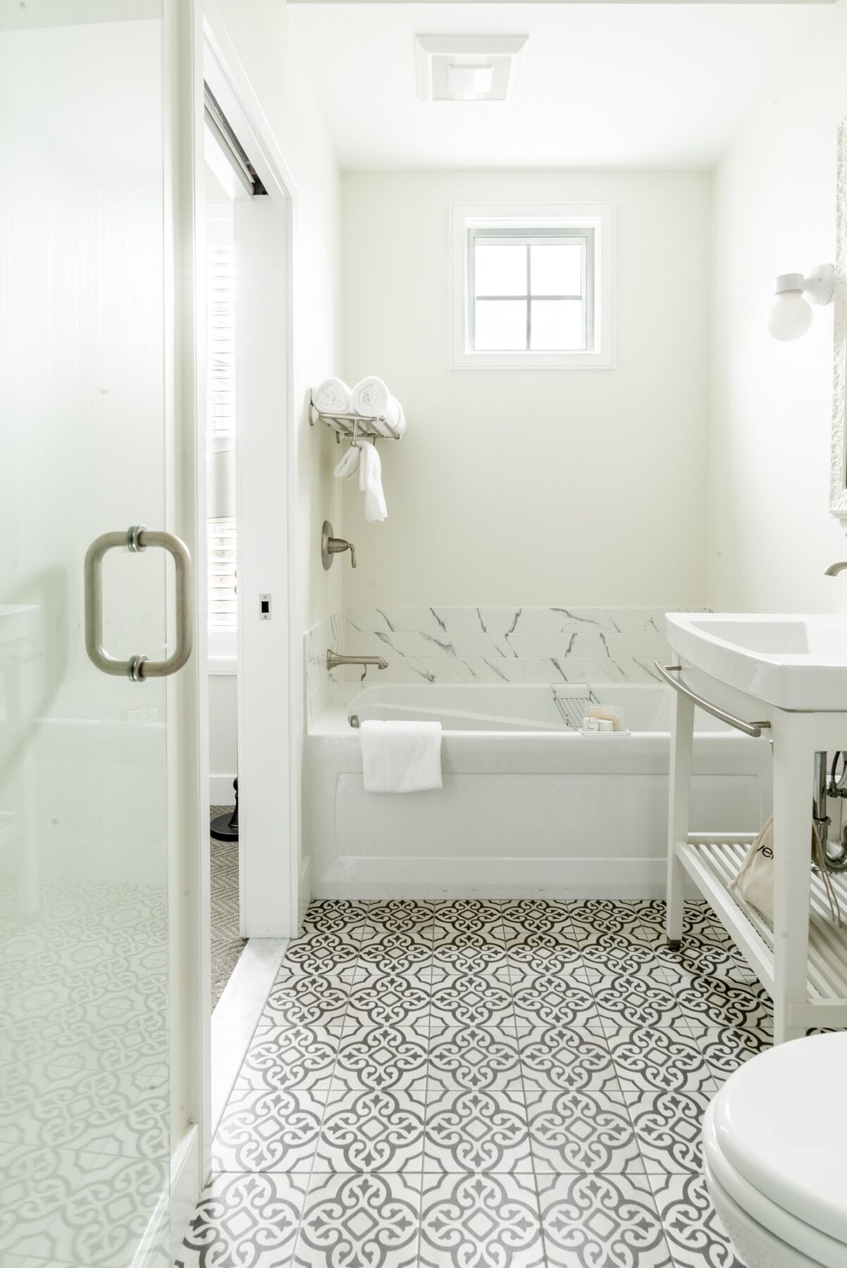 A bathroom with a bathtub, a toilet, and a sink.