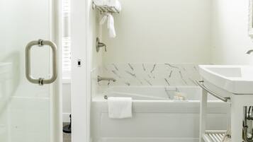 A bathroom with a bathtub, a toilet, and a sink.
