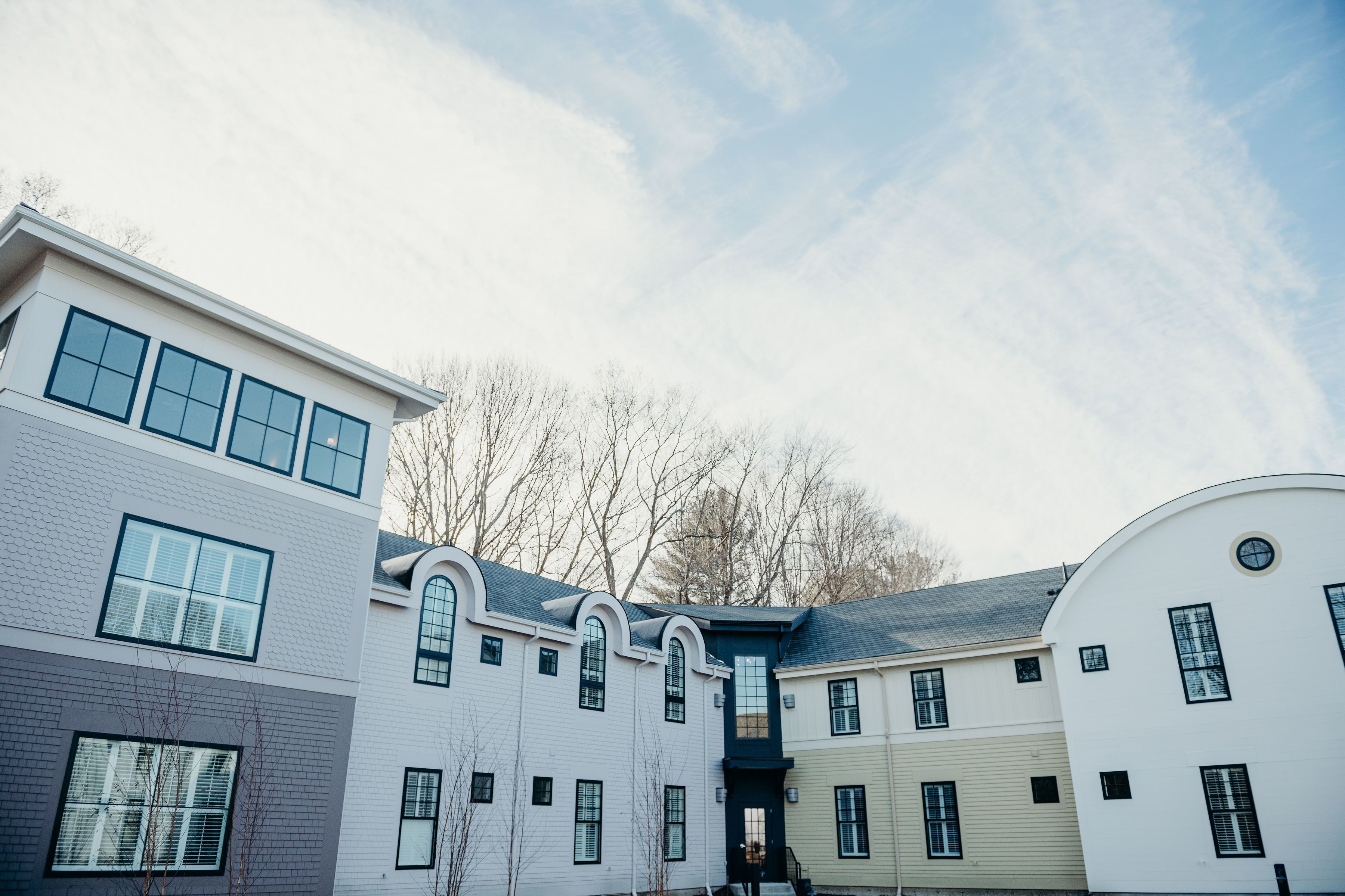 A row of modern multi-story buildings with large windows and a flat roof.