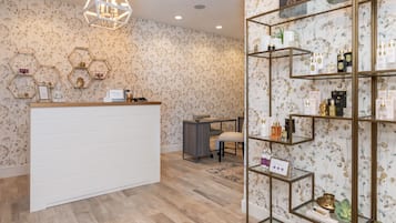 Relax in style at our reception area, featuring a comfortable seating space with a reception desk and elegant chandelier.