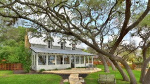 A house with a stone pathway leading to a covered patio with outdoor seating. - LOCATION!!  Lake Travis Waterfront~Pool, Spa, Outdoor Kitchen, Location (Austin)