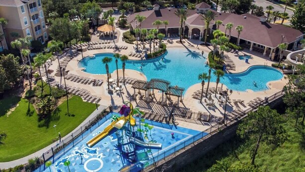 A resort with multiple swimming pools, a water park, and a variety of lounge areas. - Disney Magic Awaits: 5-BDRM, 3-Suites, Pool, Upgraded Perks,  and Tile Flooring! (Kissimmee)