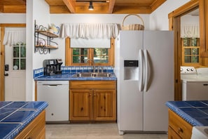 A compact kitchen with a refrigerator, a coffee maker, and a sink. - Boone Cabin with Private Waterfall, Hot Tub & Fire Pit (Boone)