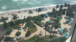 A beach resort with sun loungers, umbrellas, and palm trees. - RIGHT ON THE BEACH-Direct Oceanview Luxury 2 Bed/2Bath Condo in the Tides Resort (Hollywood)