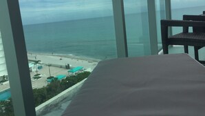 A room with a large window overlooking a beach and ocean. - RIGHT ON THE BEACH-Direct Oceanview Luxury 2 Bed/2Bath Condo in the Tides Resort (Hollywood)