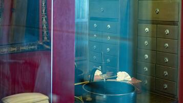 A bathroom with a mirror, a sink, a star-shaped light fixture, and a towel rack.