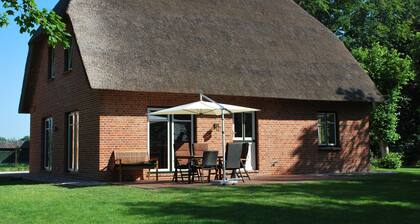 Cottage on park-like grounds with pond