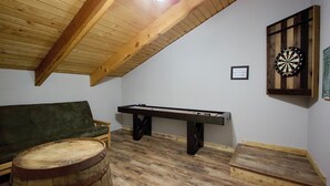A room with a wooden ceiling, a dartboard, a pool table, and a green sofa. - Clean Mountain Getaway! Excellent location in Mammoth w/full renovation (Mammoth Lakes)